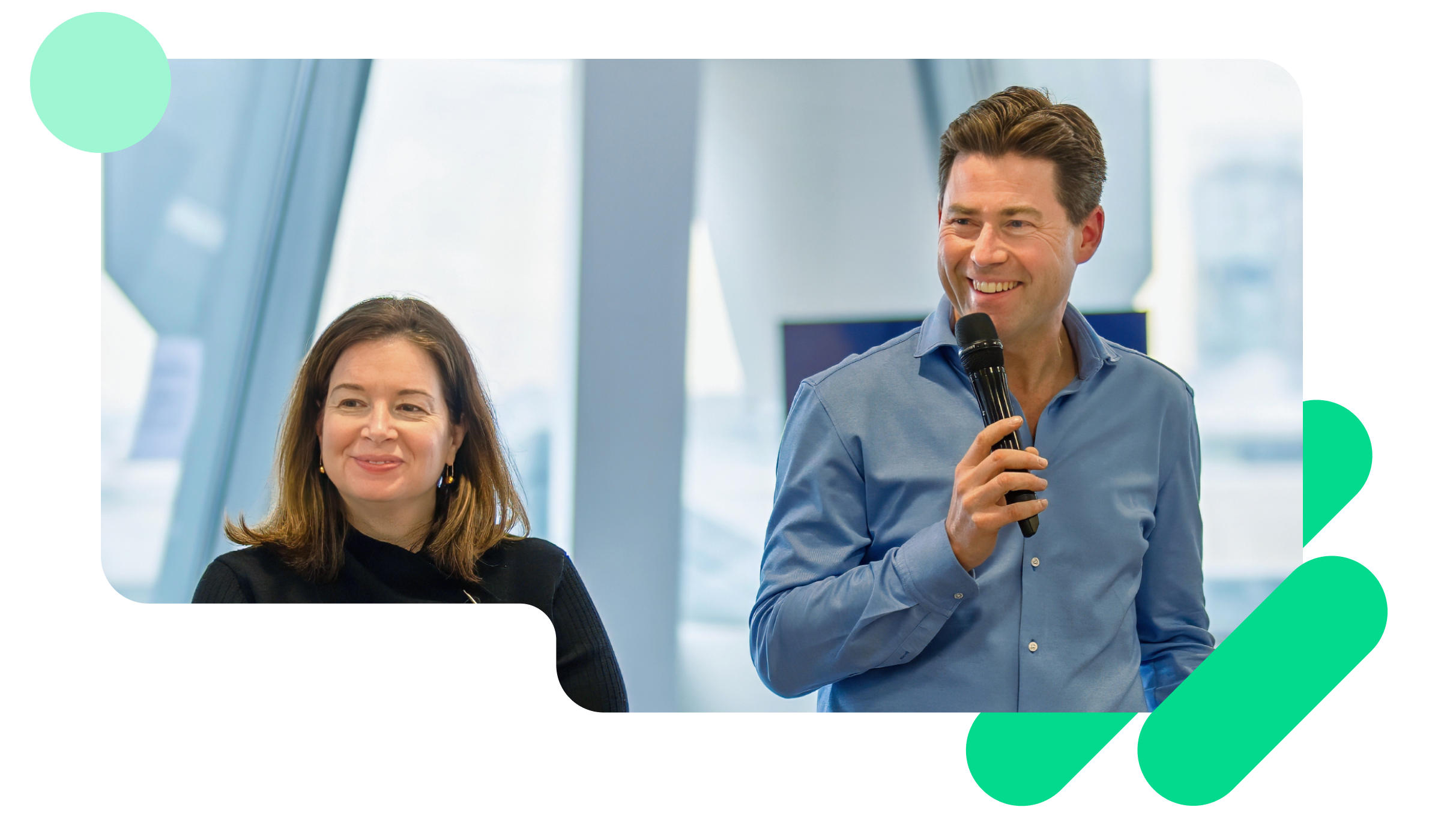 A photo of Adrian Blair, CEO, and Alicia Skubick, Chief Customer Officer, presenting in a Trustpilot company meeting